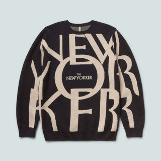 Black sweater with beige text and 'The New Yorker' logo on a light blue background