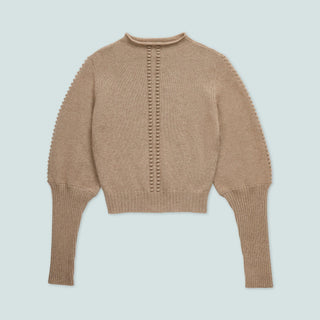 A cozy beige sweater with puffed sleeves and a button detail down the front.