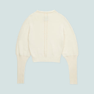 Front view of a cream-colored, lightweight sweater.